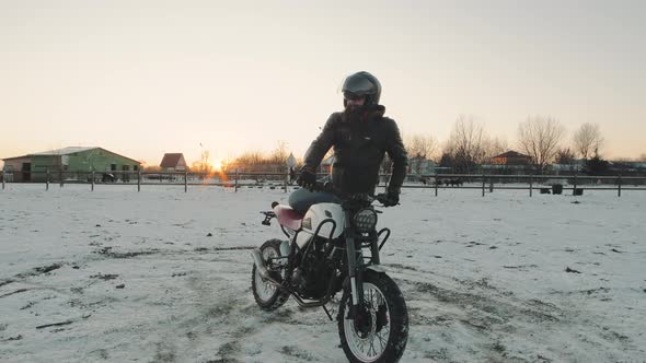 Biker Ride on Bike in the Snow Field Slow Motion