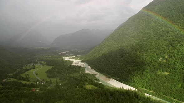 Aerial view of a cloudy landscape in Soca river with mountain range in Slovenia.