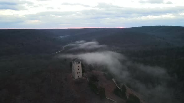 Medieval Castle Watchtower in Mystical Foggy Landscape, Aerial