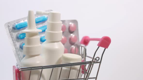 Trolley From A Supermarket With Medicines Close Up On A White Background. Health Concept.