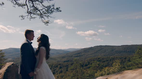 Newlywed Wedding Couple Walking in the Park. Two Young People in Love Meet Each Other's Eyes