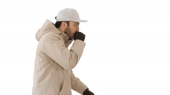 Caucasian Man in a Hat and Coat Coughing Walking on White Background