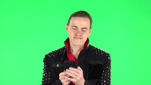 Guy Angrily Texting on His Phone. Green Screen