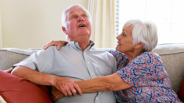 Senior couple interacting with each other in living room