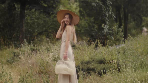 Woman with Flowers in Nature in the Summer