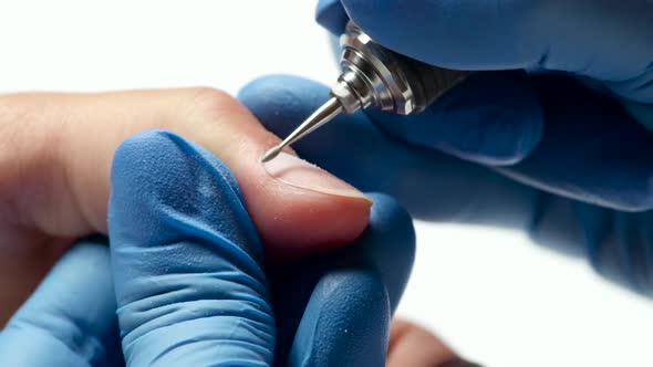 Manicurist Carries Out the Cleaning Procedure of Finger From Skin. Close Up