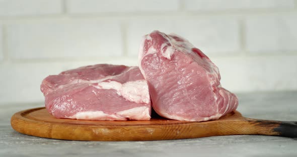 The Pulp of the Raw Pork on the Cutting Board Rotates. 