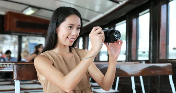 Traveler taking photo with digital camera on ferry in Hong Kong 