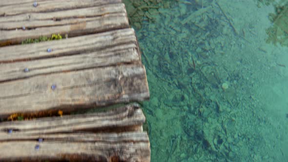 The clear water of the lake at the wooden bridge