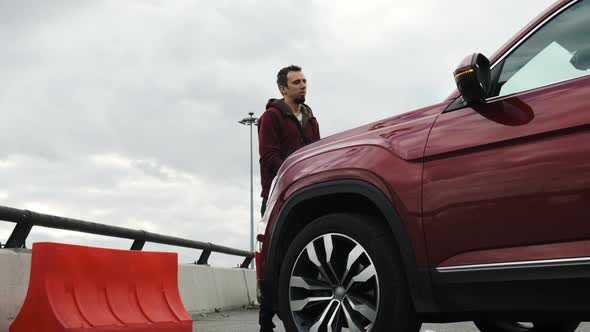 Very Funny Man Jerks the Hood of the Car and Twitches As If He Was Electrocuted.