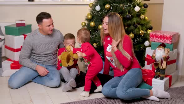Happy Family Having Fun and Playing Together Near Christmas Tree