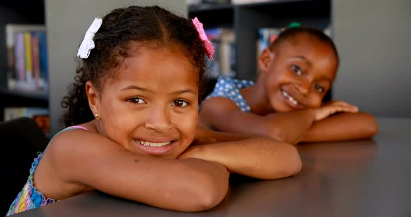 Portrait of happy schoolgirls leaning on table 4k