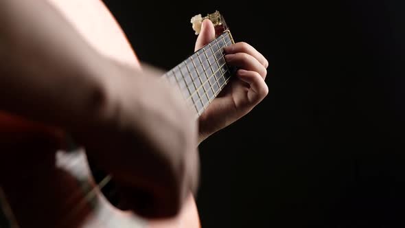 Playing Guitar in a Dark Room Closeup Fretboard Acoustic Guitar