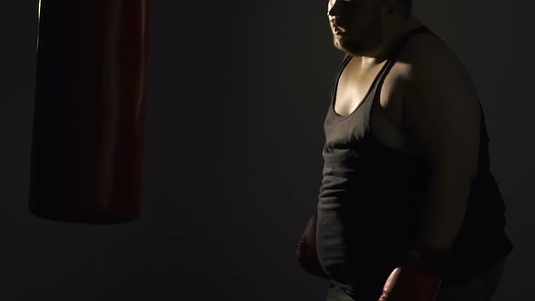 Fat Man Restoring His Breath After Active Workout With Punching Bag, Training