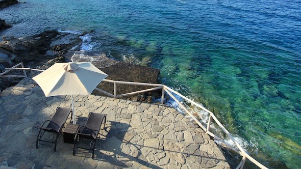 Sun Lounger And Parasol On A Beach