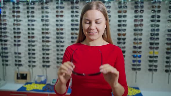 Pretty girl buying new sunglasses.