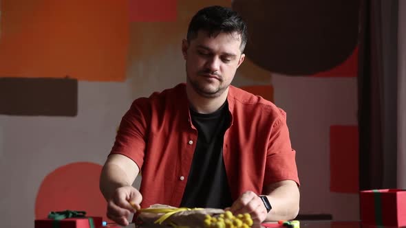 Man wrapping flowers for a Mothers Day at table