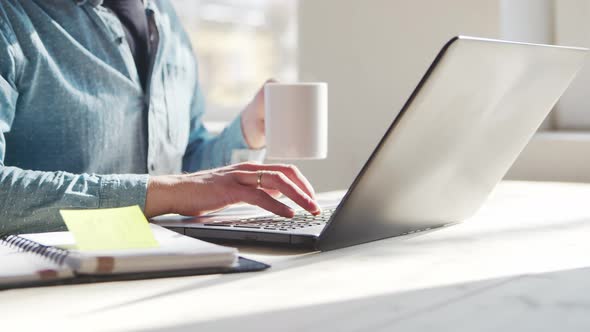 Young male entrepreneur works at home office at the computer.