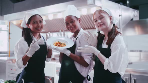 Group of schoolgirls having fun learning to cook. Female students in a cooking class.