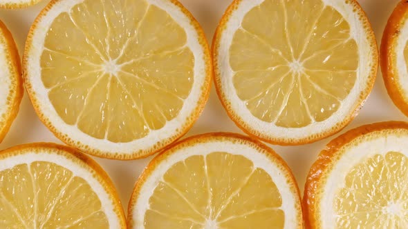 Slow Motion of Fresh Orange Slices on Orange Background