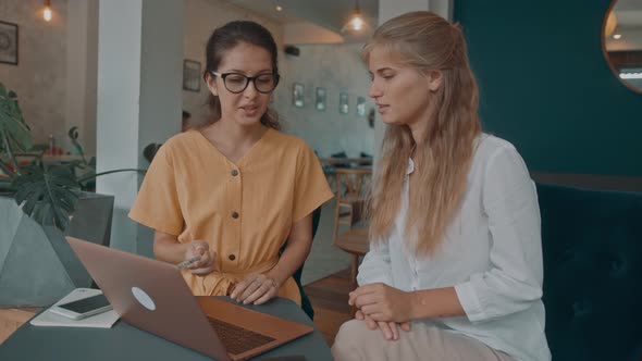 Two Girls Meet in a Coffee Shop