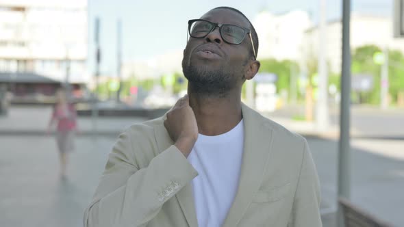 Portrait of African Man Having Neck Pain Outdoor