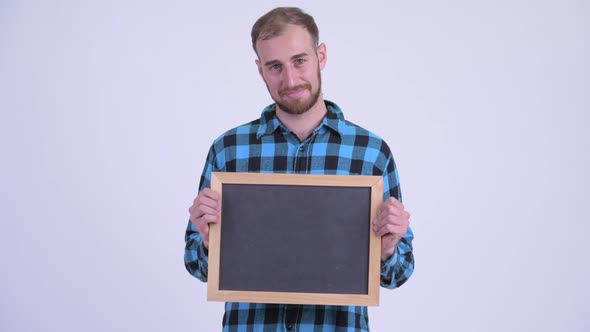 Happy Bearded Hipster Man Holding Blackboard