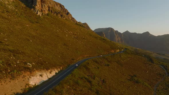 Aerial View of Low Traffic on Road in Mountain Landscape in Sunset Time