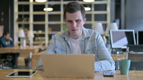 Anxious Young Designer Getting Angry on Laptop