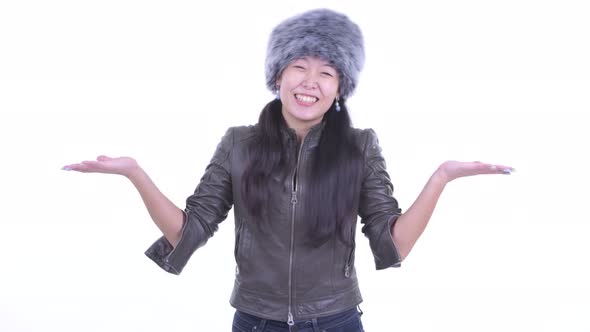 Happy Beautiful Asian Woman Shrugging Shoulders