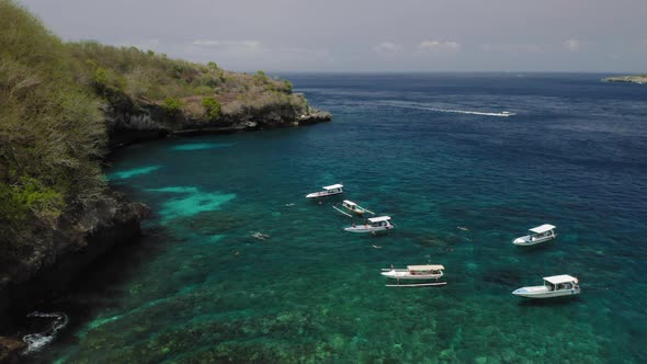 Aerial Drone Flight Over Boats Near Rocky Bay Bali Indonesia