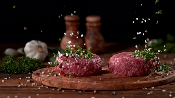 Super Slowmotion Footage of Strewing Salt and Herbs at Fresh Raw Beef Meat Burger, 1000Fps, 
