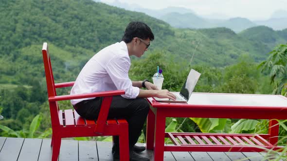 Man Typing On Laptop With Beautiful View