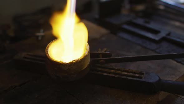 Close up of flame from gas burner melting metal for jewelry