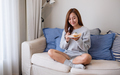 A young woman holding and eating a piece of lemon pound cake at home - PhotoDune Item for Sale