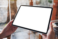 Mockup image of a woman holding digital tablet with blank white desktop screen in cafe - PhotoDune Item for Sale