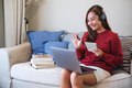 A young woman with headphone using laptop computer for online study at home - PhotoDune Item for Sale