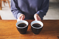 Closeup image of a woman holding two cups of coffee - PhotoDune Item for Sale