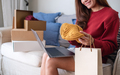 A woman using laptop for online shopping , opening shopping bags and postal parcel box at home - PhotoDune Item for Sale