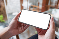 Mockup image of hands holding mobile phone with blank desktop screen - PhotoDune Item for Sale