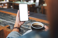 Mockup image of hands holding mobile phone with blank desktop screen while drinking coffee - PhotoDune Item for Sale