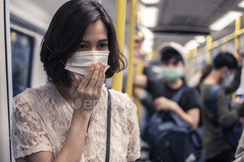 ad air pollution and coronavirus spreading over Asia. Girl wearing mask and having a cough due to bad smell and allergic symptom in underground train.