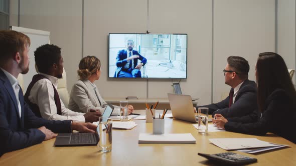 Businesspeople Talking on Video Call during Meeting