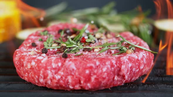 Super Slow Motion Shot of Falling Fresh Beef Hamburger Meat with Herbs on Grill at 1000 Fps