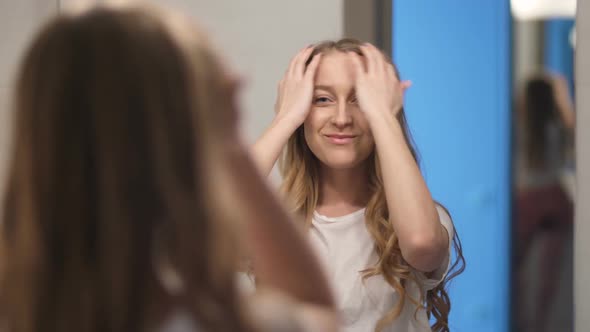 Pretty Woman Looking at Mirror with Confidence