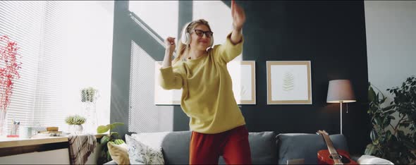 Woman in Headphones Dancing at Home