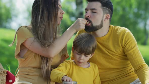 Young family eating together outdoors