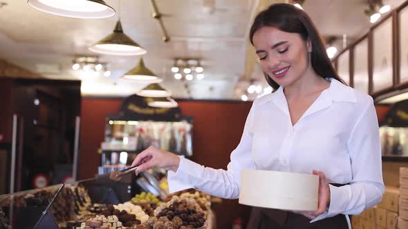 Chocolate Store. Female Seller In Confectionery Shop