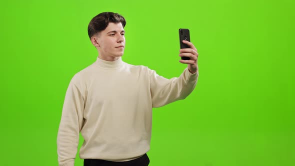 A Man is Taking a Selfie on a Smartphone