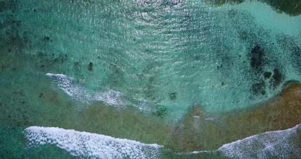 Daytime aerial abstract shot of a sunshine white sandy paradise beach and turquoise sea background i